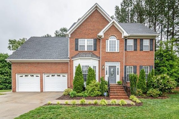 Exterior of a brick house with greenery